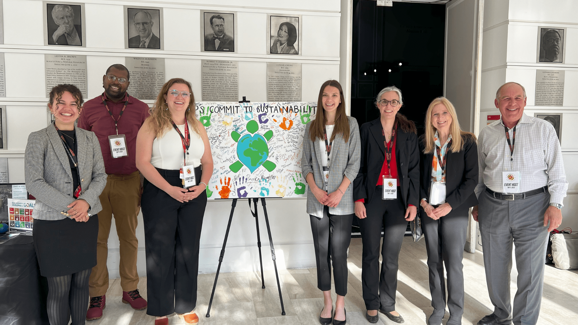 OS Staff standing infront of turtle sign